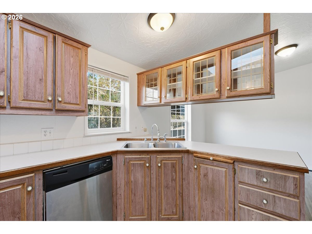 28 South Gee Creek Loop Ridgefield, WA 98642 - Photo 14 of 38 a kitchen with granite countertop a sink and cabinets