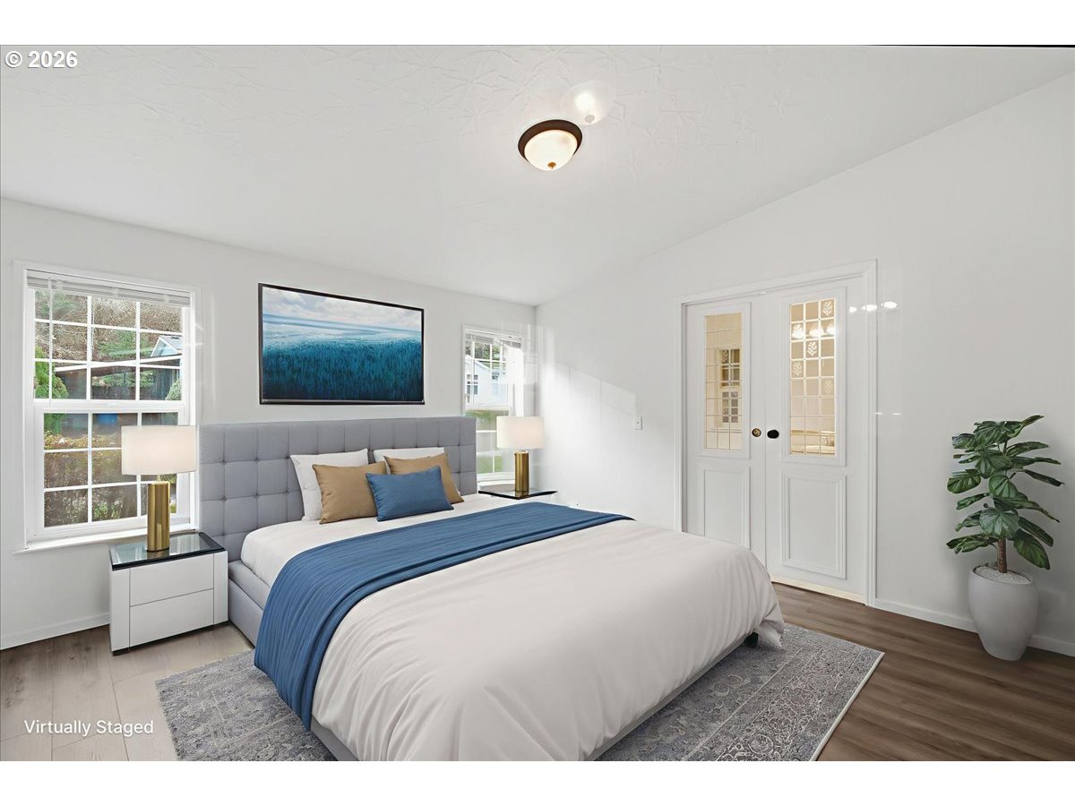 28 South Gee Creek Loop Ridgefield, WA 98642 - Photo 19 of 38 a bedroom with a large bed and a potted plant