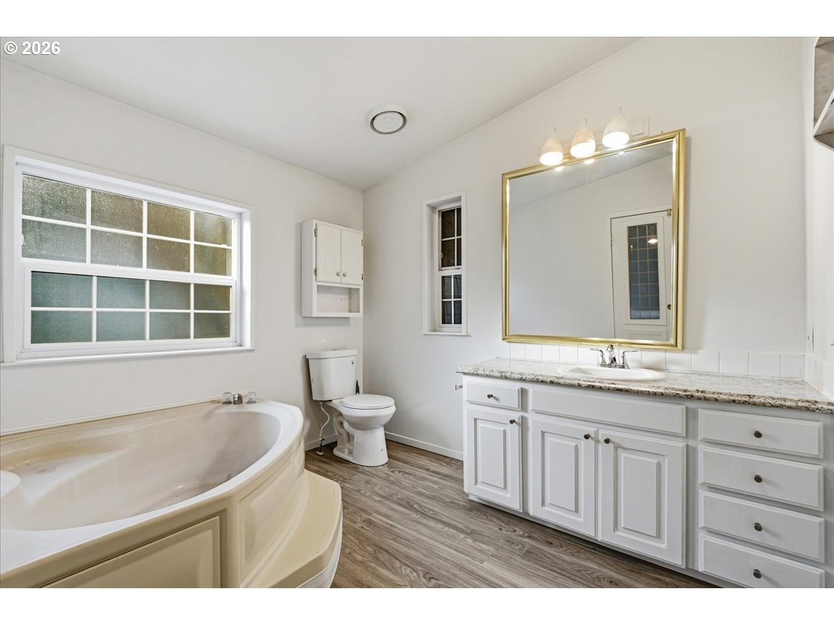 28 South Gee Creek Loop Ridgefield, WA 98642 - Photo 22 of 38 a bathroom with a granite countertop sink mirror and a bathtub