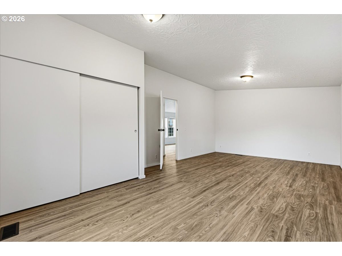 28 South Gee Creek Loop Ridgefield, WA 98642 - Photo 25 of 38 a view of an empty room with wooden floor