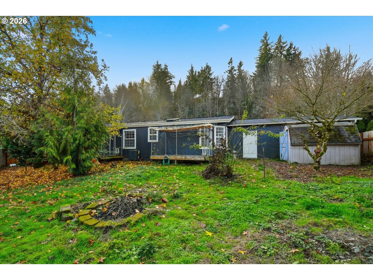 28 South Gee Creek Loop Ridgefield, WA 98642 - Photo 34 of 38 a view of a house with backyard and sitting area