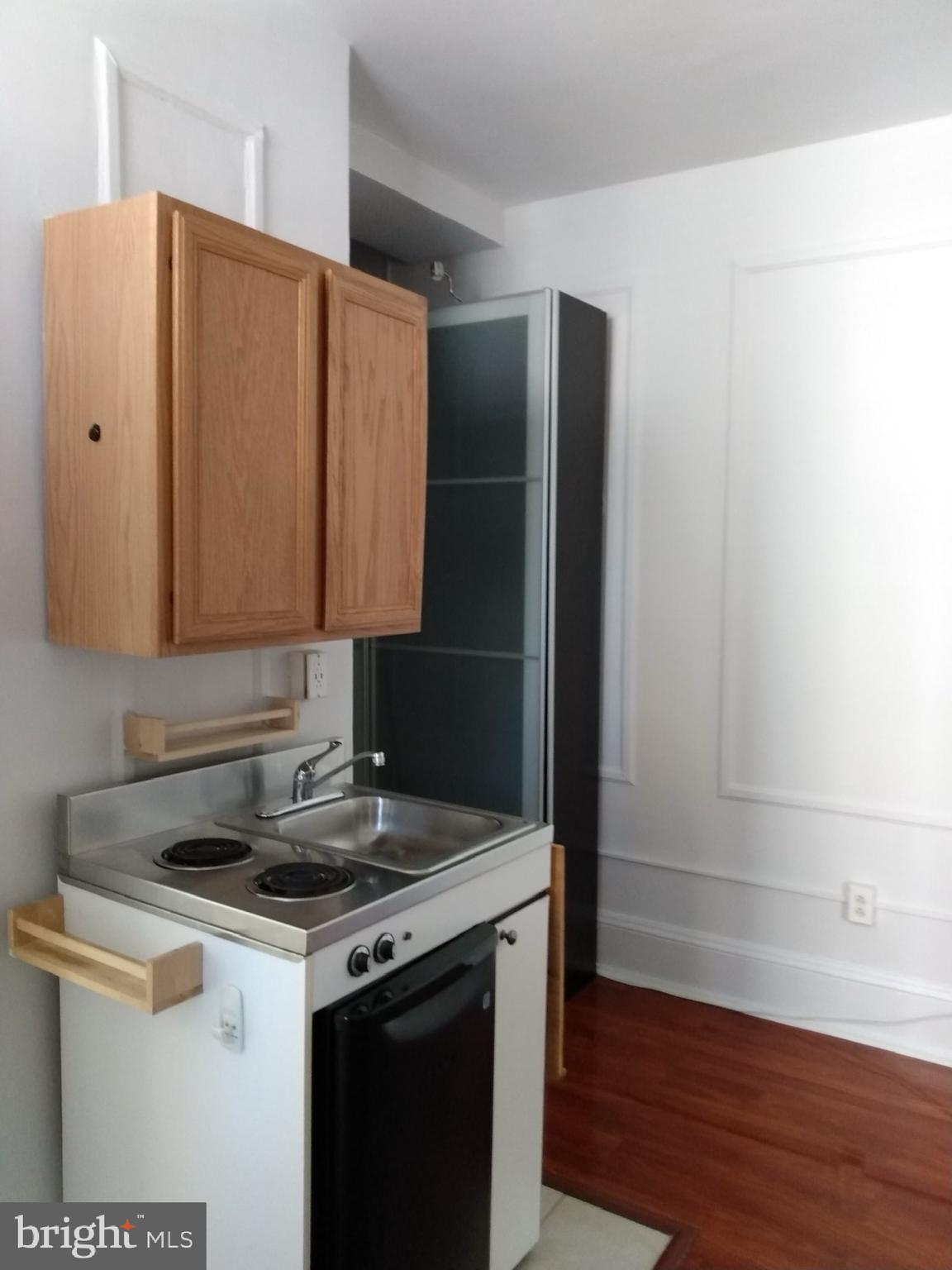 1324 Locust Street, Unit 819 Philadelphia, PA 19107 - Photo 12 of 17 a kitchen with a sink and a refrigerator