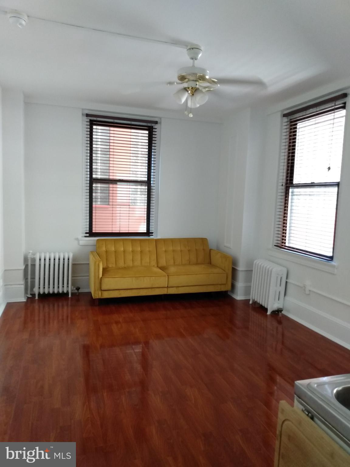 1324 Locust Street, Unit 819 Philadelphia, PA 19107 - Photo 13 of 17 a view of a room with window hardwood floor and a kitchen