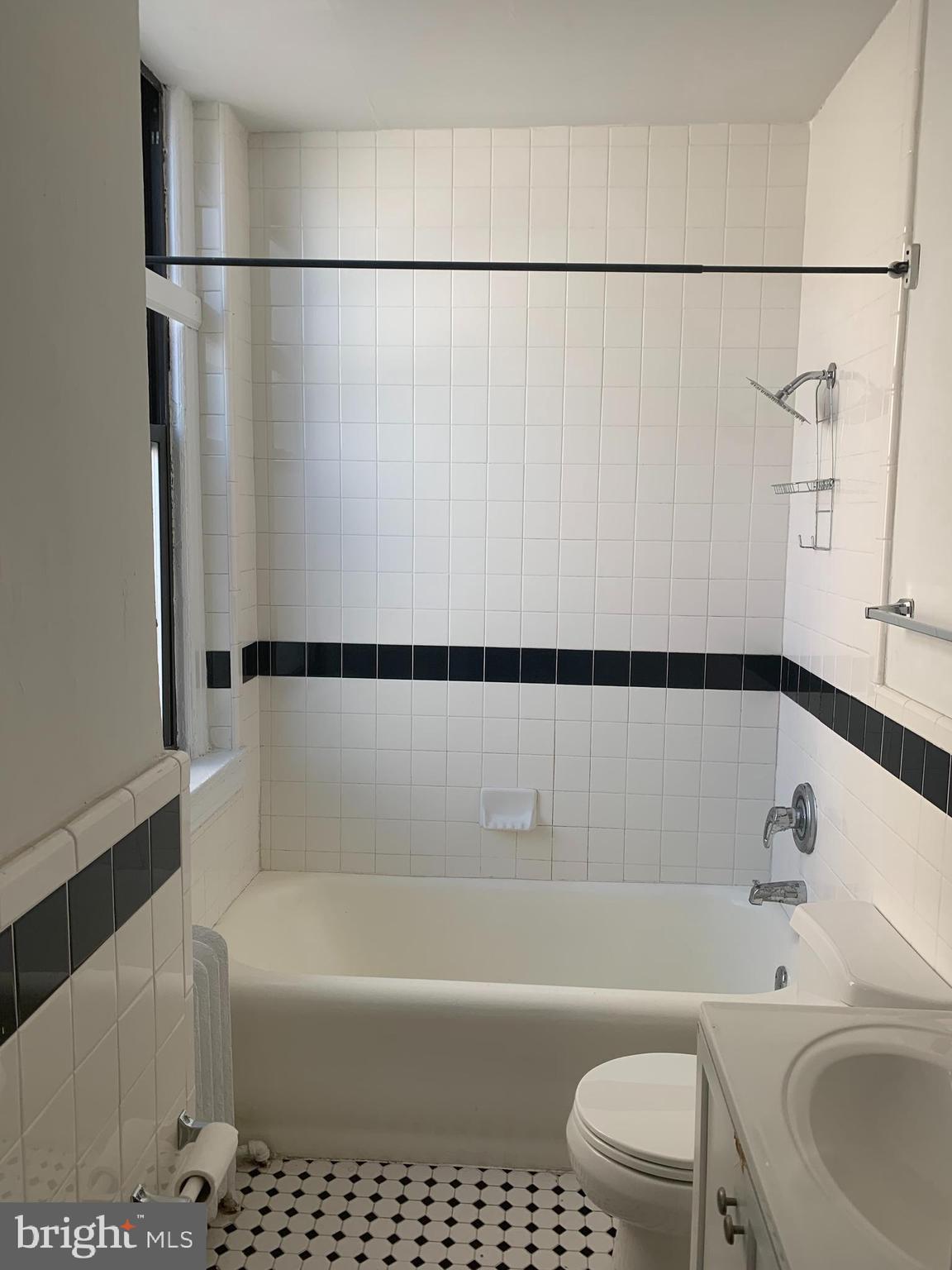 1324 Locust Street, Unit 819 Philadelphia, PA 19107 - Photo 15 of 17 a bathroom with a bathtub a toilet and a shower