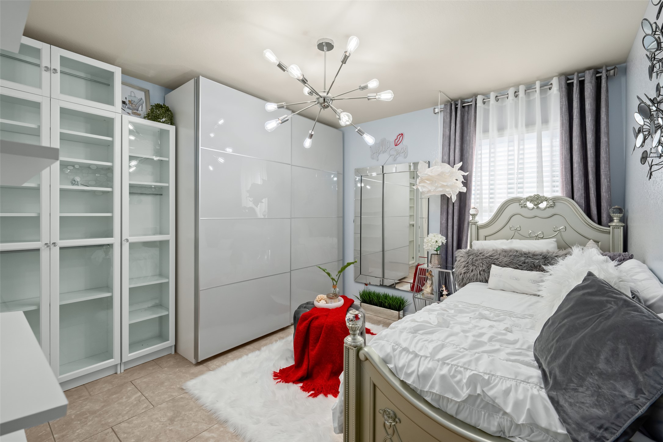 355 Evening Star Kyle, TX 78640 - Photo 14 of 21 a bedroom with a bed and a chandelier