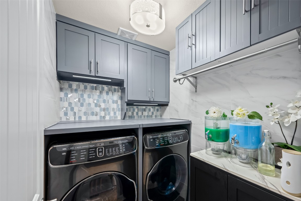 355 Evening Star Kyle, TX 78640 - Photo 17 of 21 Washer & dryer remain with the property. The cabinets offer additional storage for all cleansers and soaps.