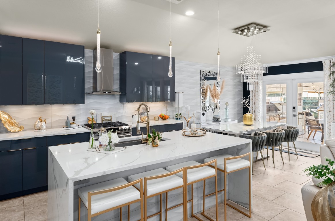 355 Evening Star Kyle, TX 78640 - Photo 6 of 21 Kitchen featuring modern cabinets, a kitchen bar, and a good sized pantry.