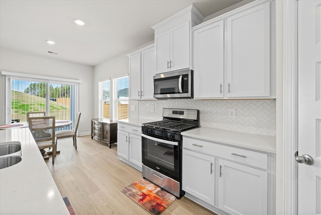 106 Purcell Way Easley, SC 29642 - Photo 9 of 39 Bright and open, this kitchen offers ample counter space and a seamless flow into the dining area.
