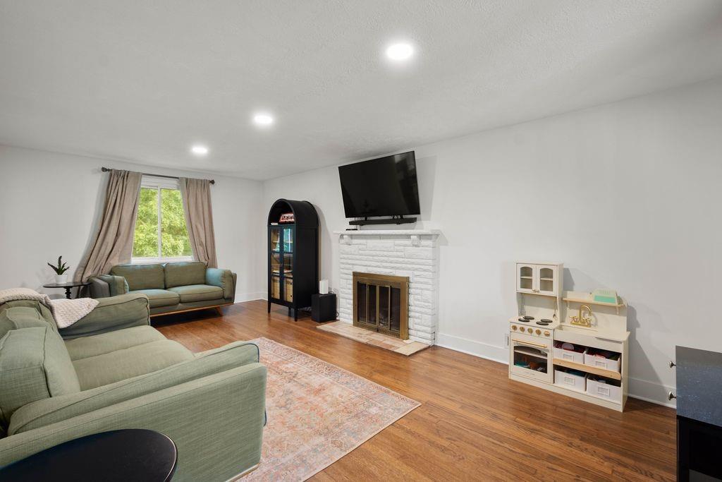2026 Borland Road Pittsburgh, PA 15243 - Photo 7 of 34 a living room with furniture a fireplace and a flat screen tv