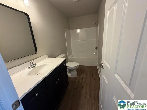 a bathroom with a sink a toilet a shower and a mirror