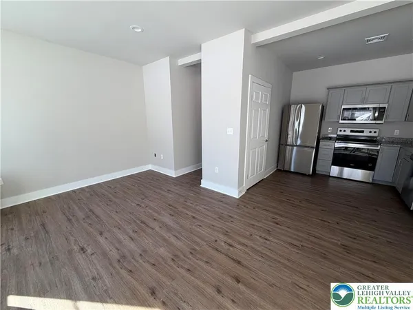a view of kitchen with furniture and wooden floor