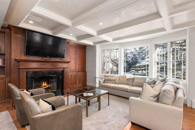 825 Ute Avenue, Unit A Aspen, CO 81611 - Photo 1 of 23 a living room with furniture a flat screen tv and a fireplace