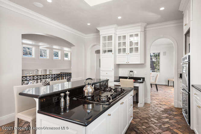 825 Ute Avenue, Unit A Aspen, CO 81611 - Photo 11 of 23 a kitchen with stainless steel appliances granite countertop a stove a sink and a refrigerator
