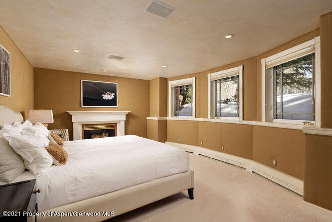 825 Ute Avenue, Unit A Aspen, CO 81611 - Photo 13 of 23 a bedroom with a large bed and a tv