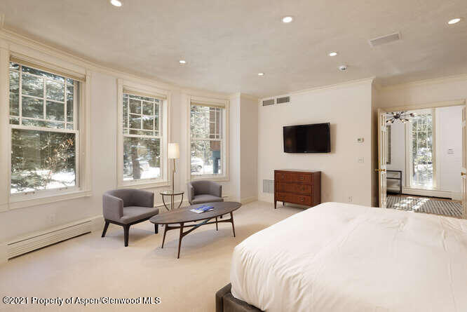 825 Ute Avenue, Unit A Aspen, CO 81611 - Photo 16 of 23 a spacious bedroom with a bed and a flat screen tv