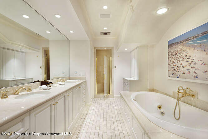825 Ute Avenue, Unit A Aspen, CO 81611 - Photo 17 of 23 a spacious bathroom with a double vanity sink a mirror and a bathtub