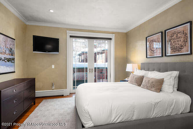 825 Ute Avenue, Unit A Aspen, CO 81611 - Photo 18 of 23 a bedroom with a bed and a flat screen tv