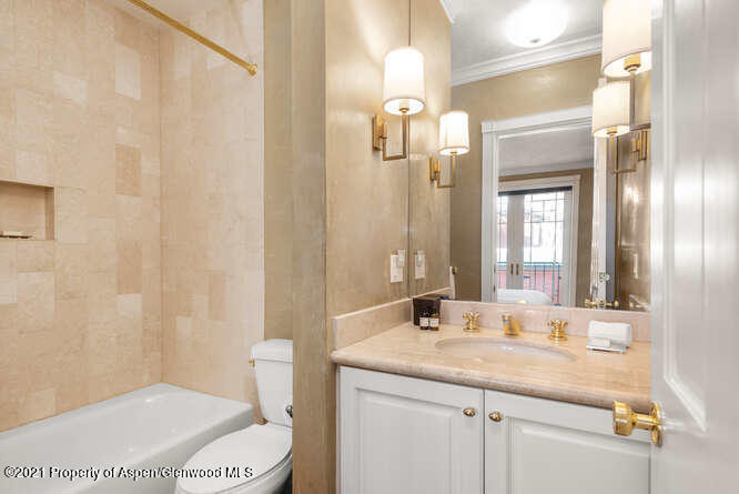825 Ute Avenue, Unit A Aspen, CO 81611 - Photo 19 of 23 a bathroom with a granite countertop sink and a mirror