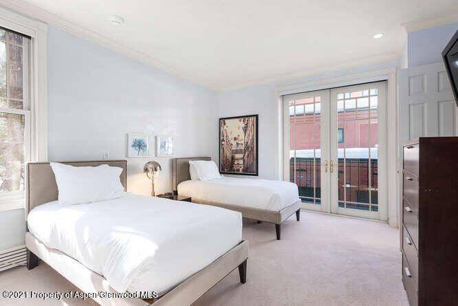 825 Ute Avenue, Unit A Aspen, CO 81611 - Photo 20 of 23 a bedroom with bed and a large window