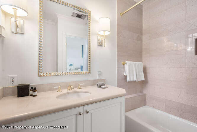 825 Ute Avenue, Unit A Aspen, CO 81611 - Photo 21 of 23 a bathroom with a sink double vanity granite tub shower and a mirror