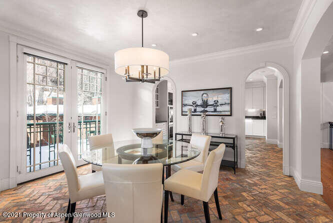 825 Ute Avenue, Unit A Aspen, CO 81611 - Photo 9 of 23 a dining room with furniture a chandelier and wooden floor