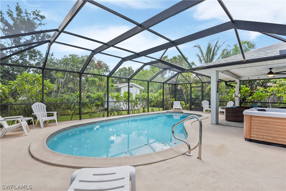 12478 Dolphin Road Bokeelia, FL 33922 - Photo 1 of 25 a swimming pool with outdoor seating and patio