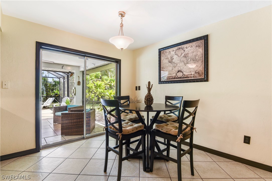 12478 Dolphin Road Bokeelia, FL 33922 - Photo 15 of 25 a view of a dining room with furniture and a window