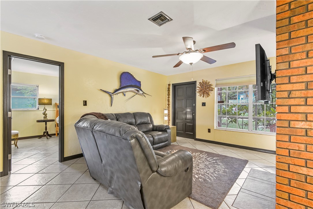 12478 Dolphin Road Bokeelia, FL 33922 - Photo 16 of 25 a living room with furniture and a large window