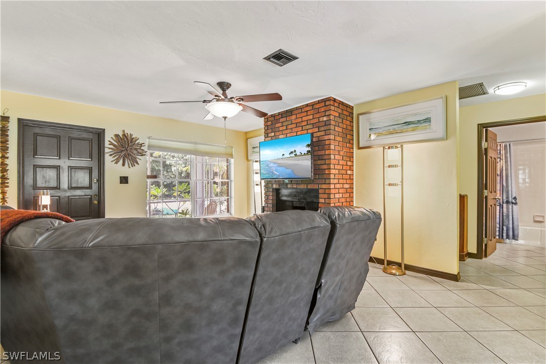 12478 Dolphin Road Bokeelia, FL 33922 - Photo 17 of 25 a living room with furniture and a fireplace