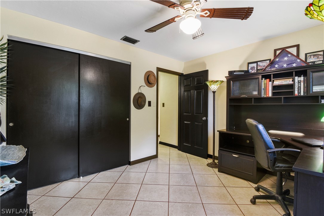 12478 Dolphin Road Bokeelia, FL 33922 - Photo 19 of 25 a view of a workspace with furniture and chandelier