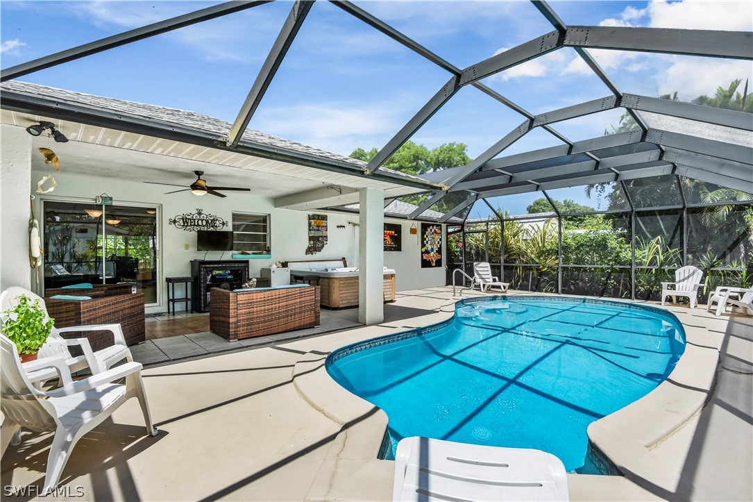 12478 Dolphin Road Bokeelia, FL 33922 - Photo 21 of 25 a view of a patio with table and chairs under an umbrella