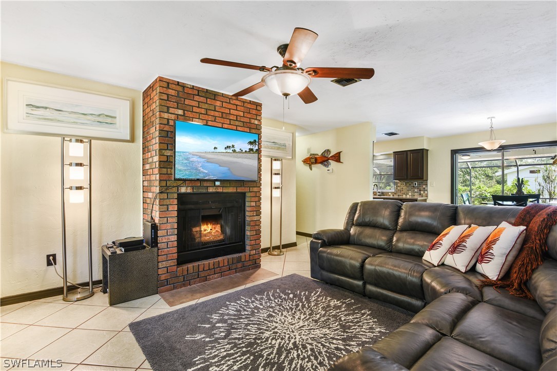 12478 Dolphin Road Bokeelia, FL 33922 - Photo 3 of 25 a living room with furniture and a fireplace