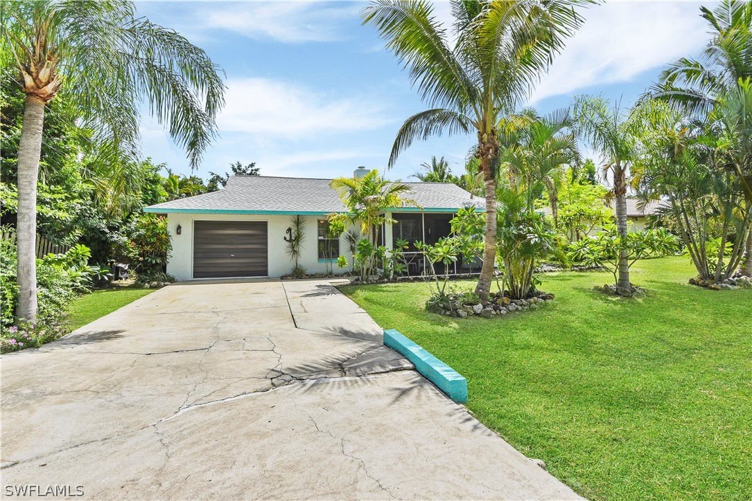 12478 Dolphin Road Bokeelia, FL 33922 - Photo 4 of 25 a front view of a house with a yard