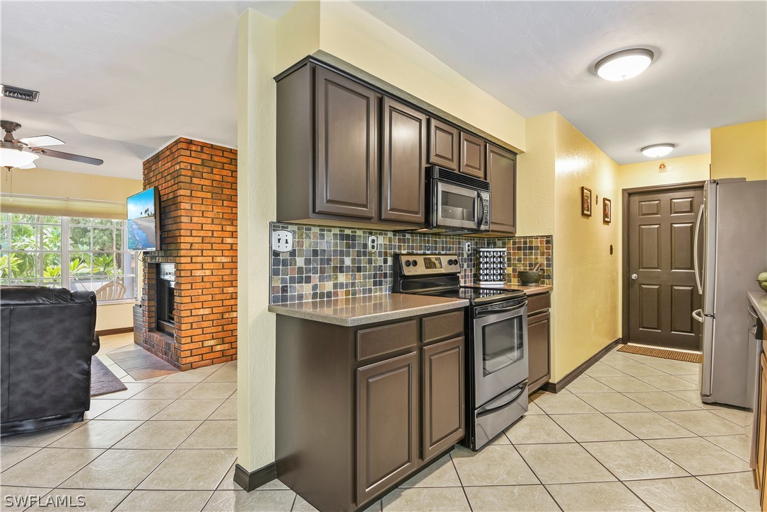 12478 Dolphin Road Bokeelia, FL 33922 - Photo 6 of 25 a kitchen with stainless steel appliances granite countertop a stove and a sink