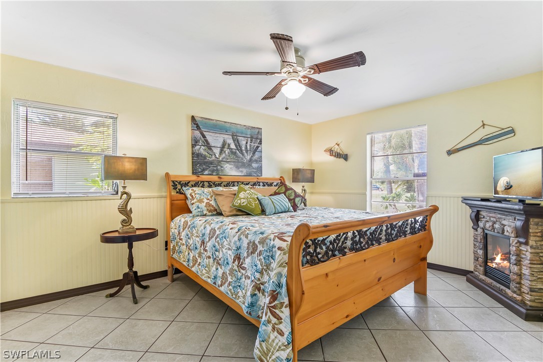 12478 Dolphin Road Bokeelia, FL 33922 - Photo 9 of 25 a bedroom with a bed and wooden floor