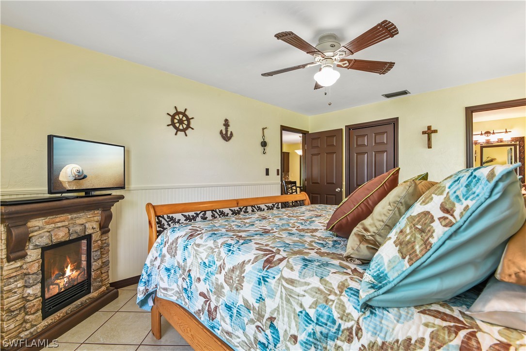 12478 Dolphin Road Bokeelia, FL 33922 - Photo 10 of 25 a bed sitting in a bedroom and chandelier