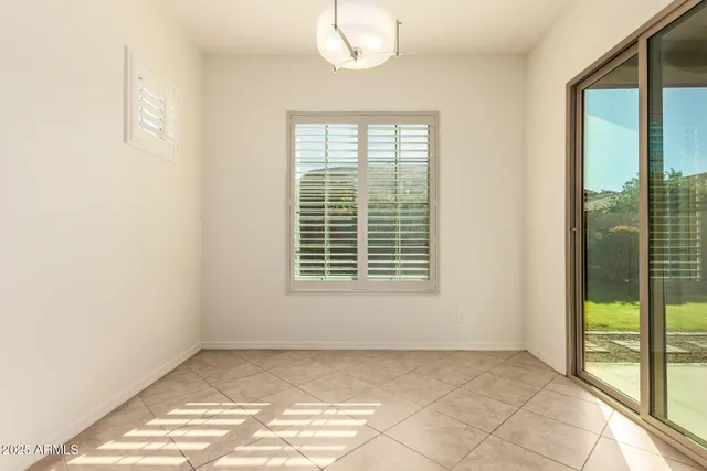 a large kitchen with stainless steel appliances wooden cabinets and a stove top oven