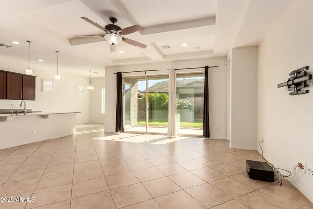 a view of a livingroom with a ceiling fan and window