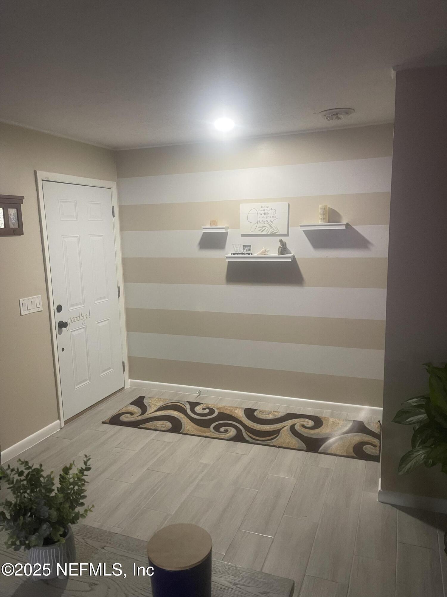 5203 Clarendon Road Jacksonville, FL 32205 - Photo 3 of 12 a room with a water heater and wooden cabinets