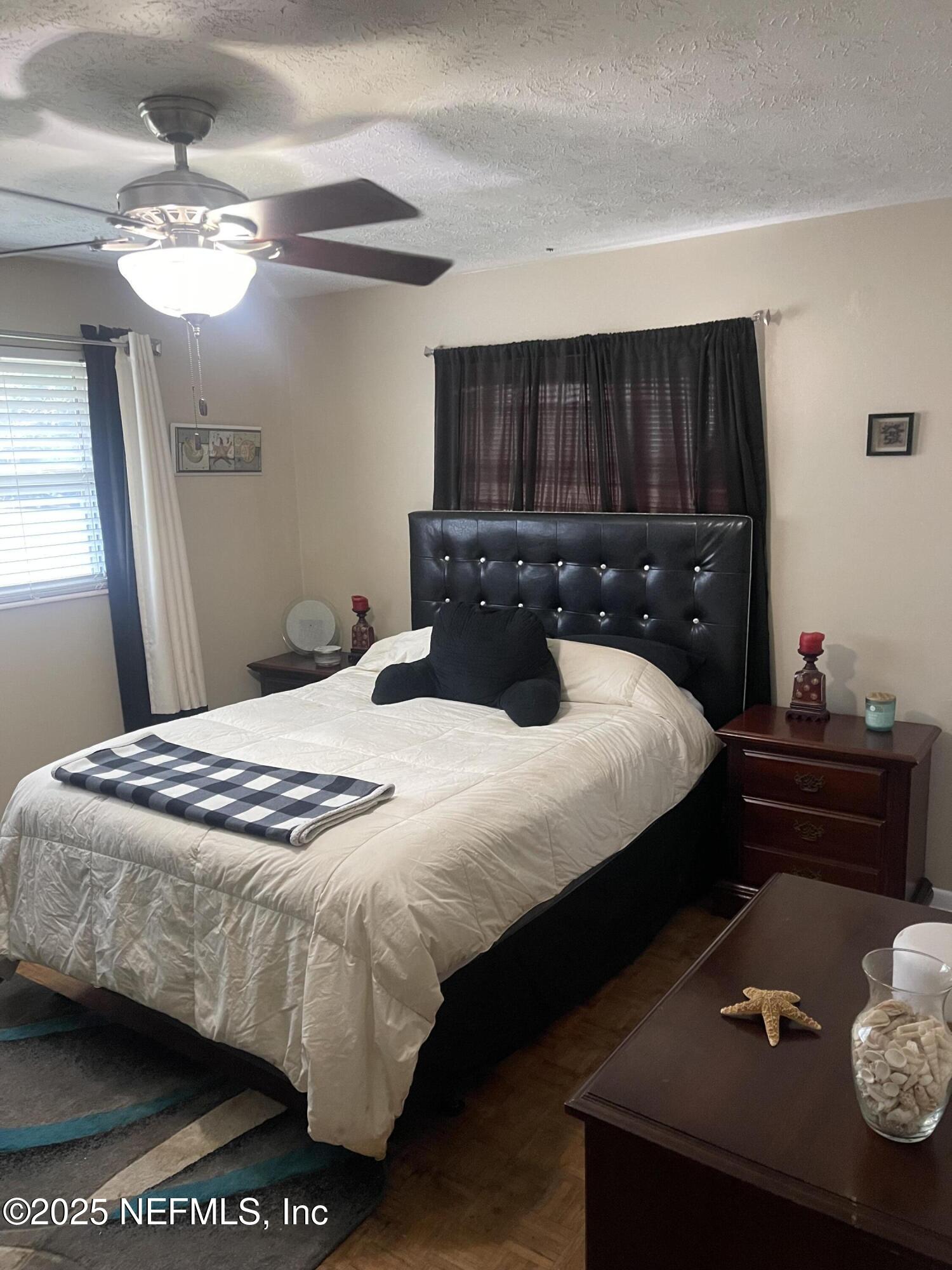 5203 Clarendon Road Jacksonville, FL 32205 - Photo 8 of 12 a bedroom with a bed and a mirror