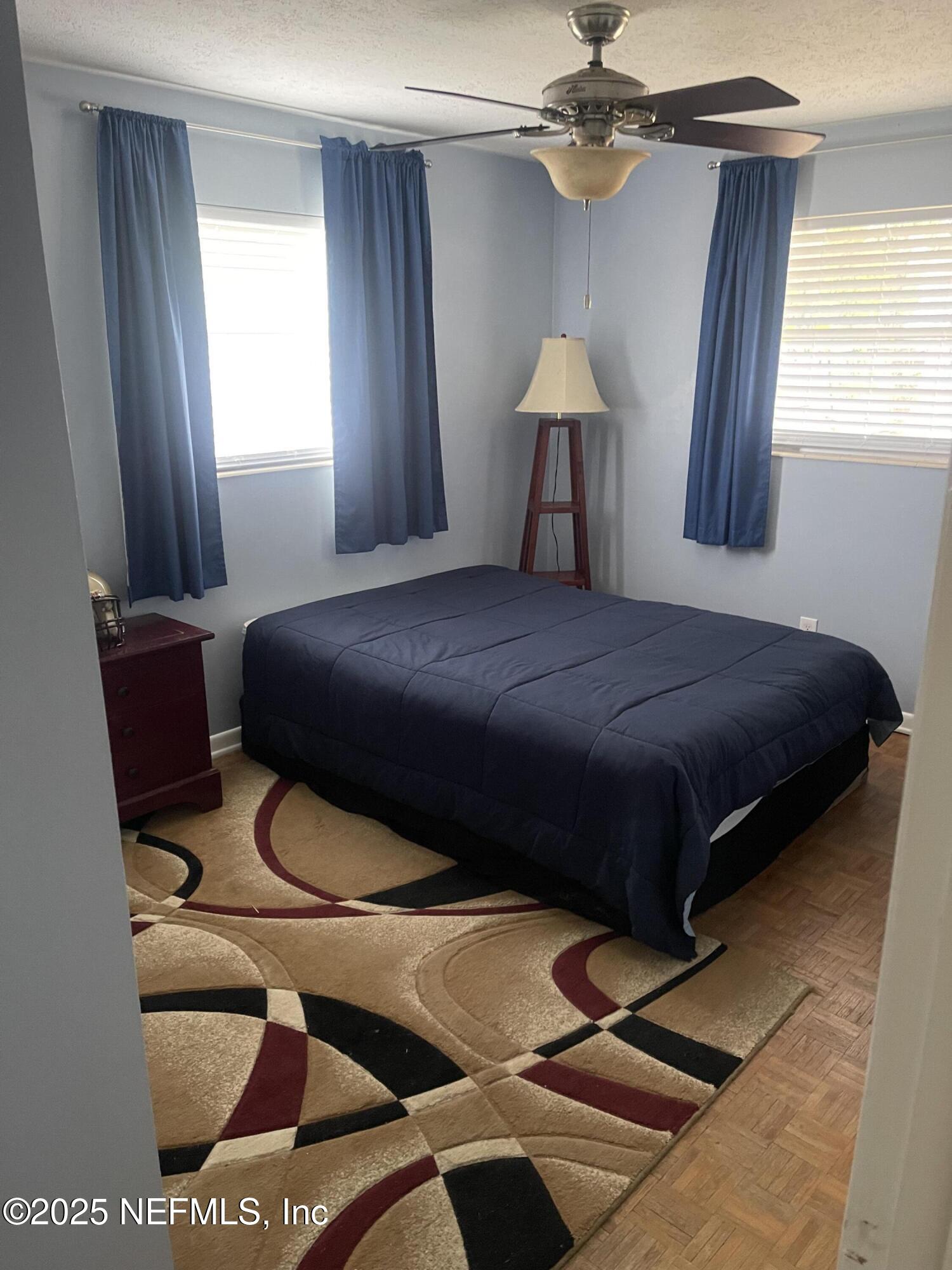 5203 Clarendon Road Jacksonville, FL 32205 - Photo 9 of 12 a bedroom with a bed and a chandelier