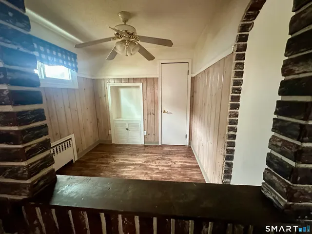 a view of a livingroom with a window and wooden floor
