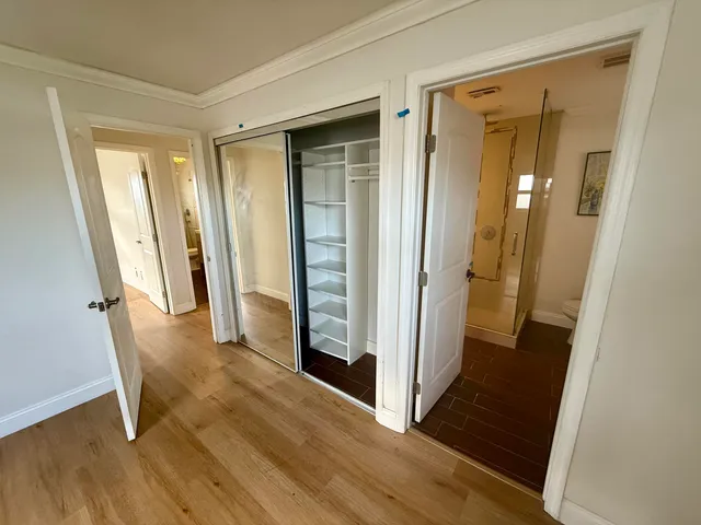 an entryway door with wooden floor and staircase