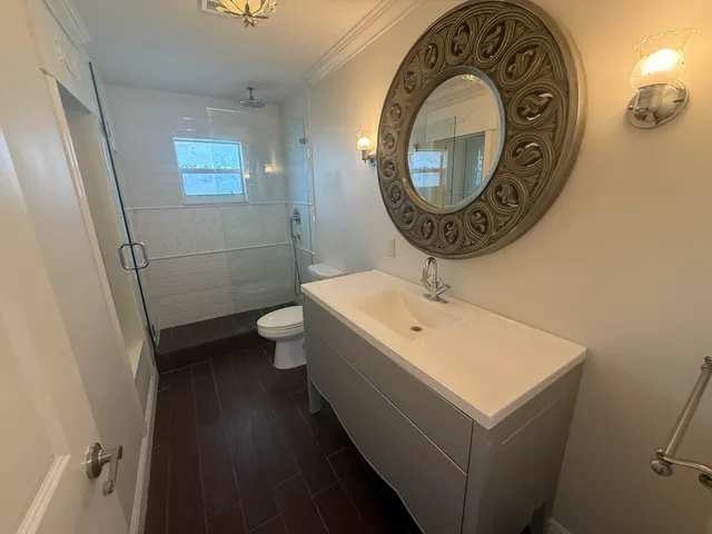 a bathroom with a toilet a sink and a mirror