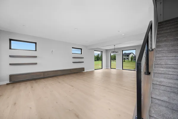 an empty room with closet and fan