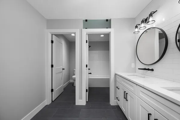 a bathroom with a sink a toilet and a mirror