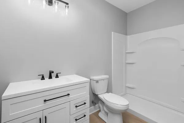 a bathroom with a double vanity sink a toilet and a mirror