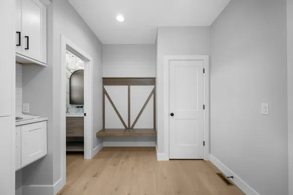 a view of an empty room with a chandelier fan
