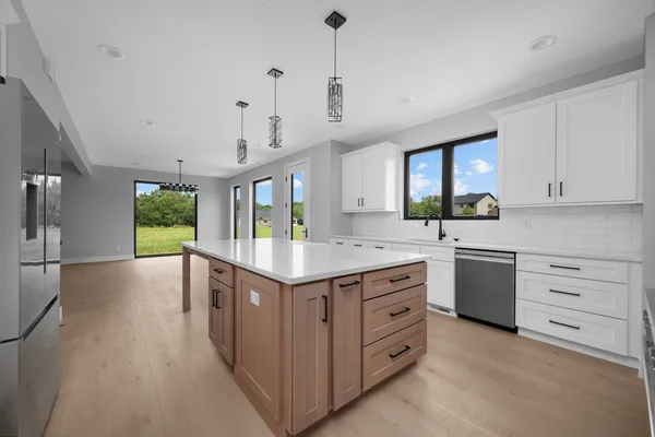 a kitchen with kitchen island granite countertop a stove and a sink