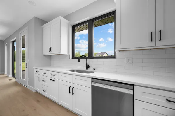 a kitchen with appliances cabinets and a sink